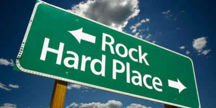 “Rock, Hard Place” Road Sign with dramatic clouds and sky.