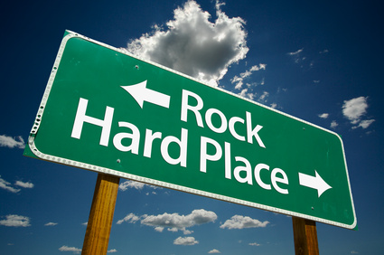 “Rock, Hard Place” Road Sign with dramatic clouds and sky.