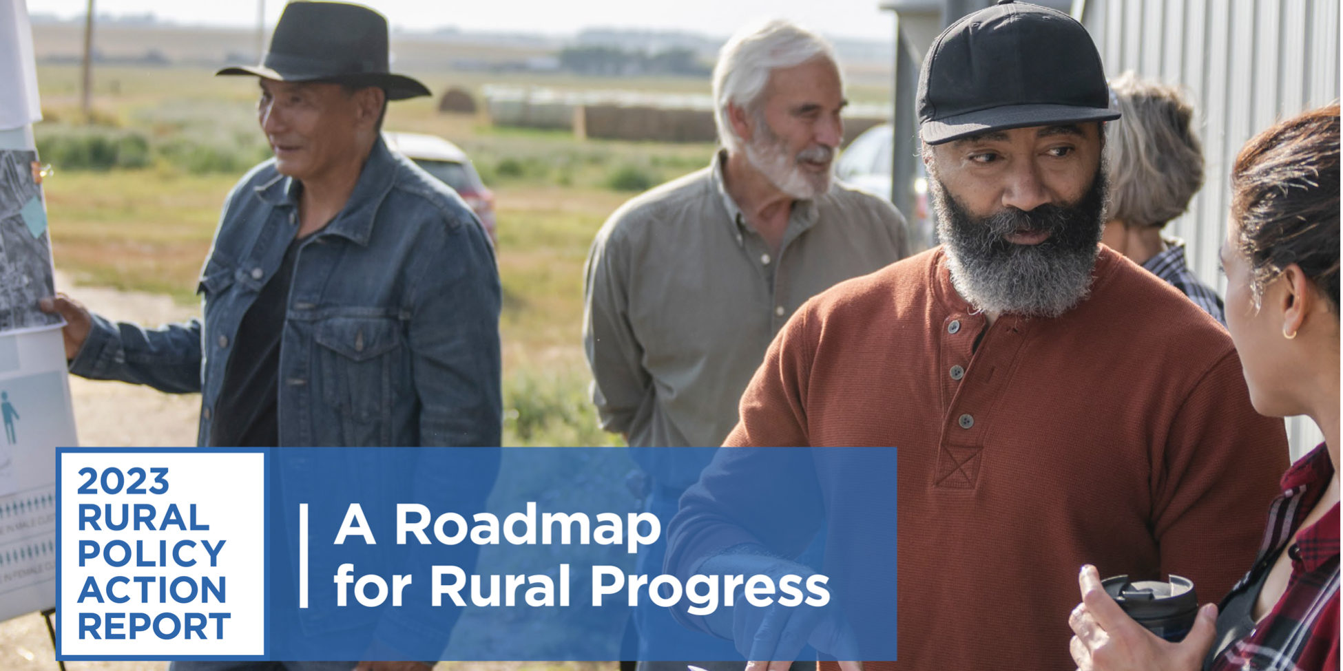 Graphic with blue logo that reads "2023 rural policy action report / a roadmap for rural progress." Behind the logo is an image of a bearded African American man wearing a black baseball cap and orange henley talking to a woman in a plaid shirt holding a thermos mug. Behind them to the left is a man in a cowboy hat and jean jacket holding a sign next to an older gentleman talking to a woman.