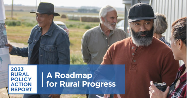 Graphic with blue logo that reads "2023 rural policy action report / a roadmap for rural progress." Behind the logo is an image of a bearded African American man wearing a black baseball cap and orange henley talking to a woman in a plaid shirt holding a thermos mug. Behind them to the left is a man in a cowboy hat and jean jacket holding a sign next to an older gentleman talking to a woman.