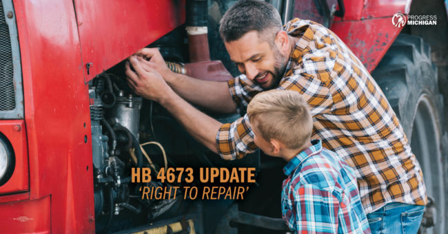 Image of a father and his son wearing plaid shirts tending to a tractor repair.